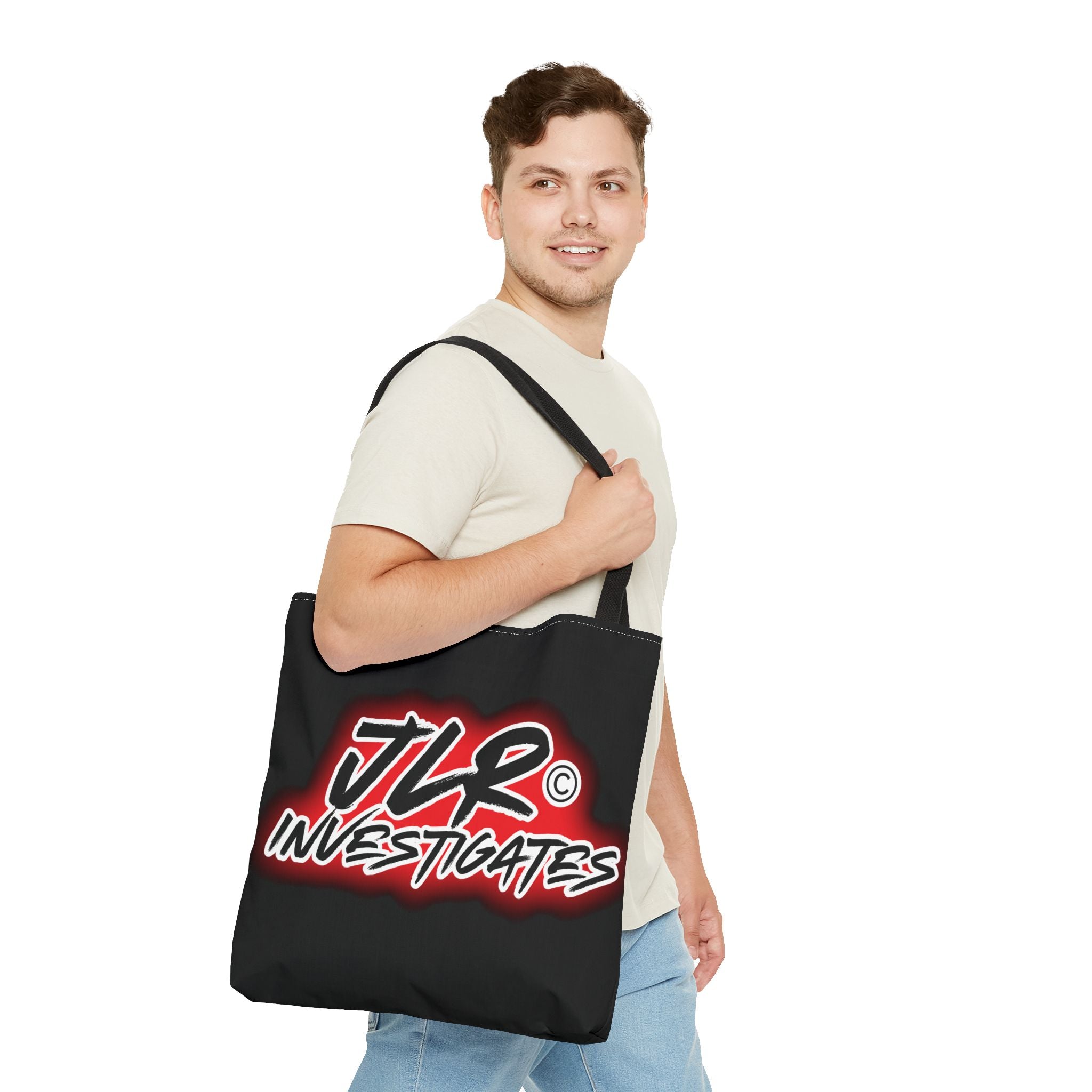 Man holding a black tote bag with 'JLR Investigates' logo on a white background