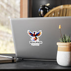 Resilience phoenix sticker displayed on a surface next to a white cup
