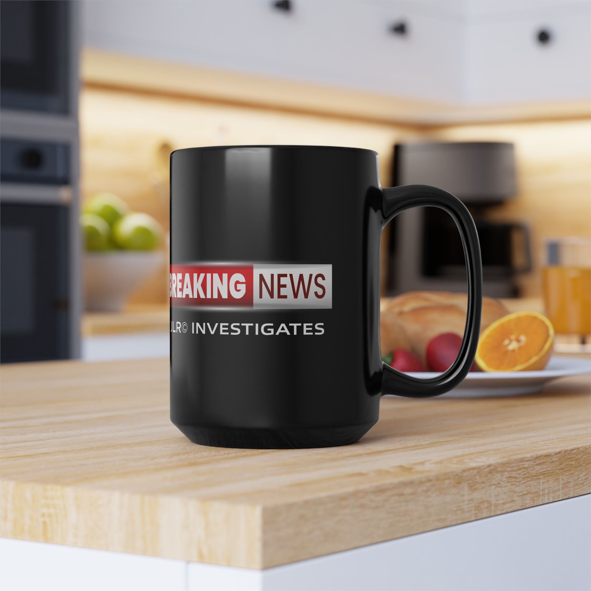 Black mug with 'Breaking News' and 'JLR INVESTIGATES' text on a kitchen counter.