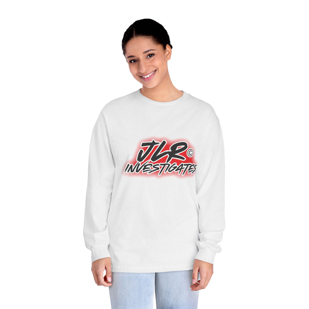 Woman wearing White long sleeve unisex t-shirt featuring bold 'JLR© Investigates' graffiti-style logo in red, white, and black 