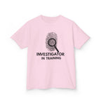 Investigator in Training Kids T-Shirt in Light Pink with bold "INVESTIGATOR IN TRAINING" fingerprint design — perfect gift for young mystery lovers