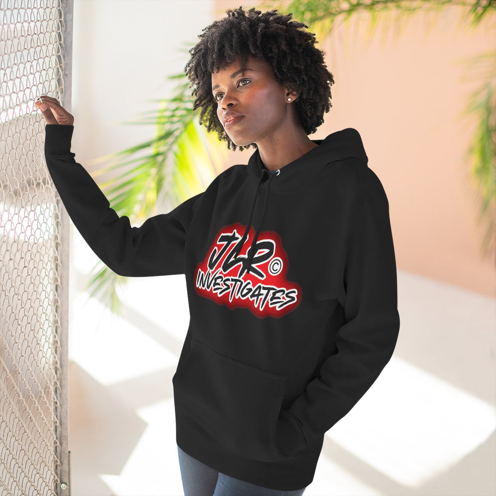 Woman wearing JLR© Bold Logo Hoodie in Black — graffiti-style JLR Investigates graphic on a pullover hoodie with kangaroo pocket and adjustable drawstring hood