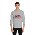Man wearing grey long sleeve unisex t-shirt featuring bold 'JLR© Investigates' graffiti-style logo in red, white, and black.
