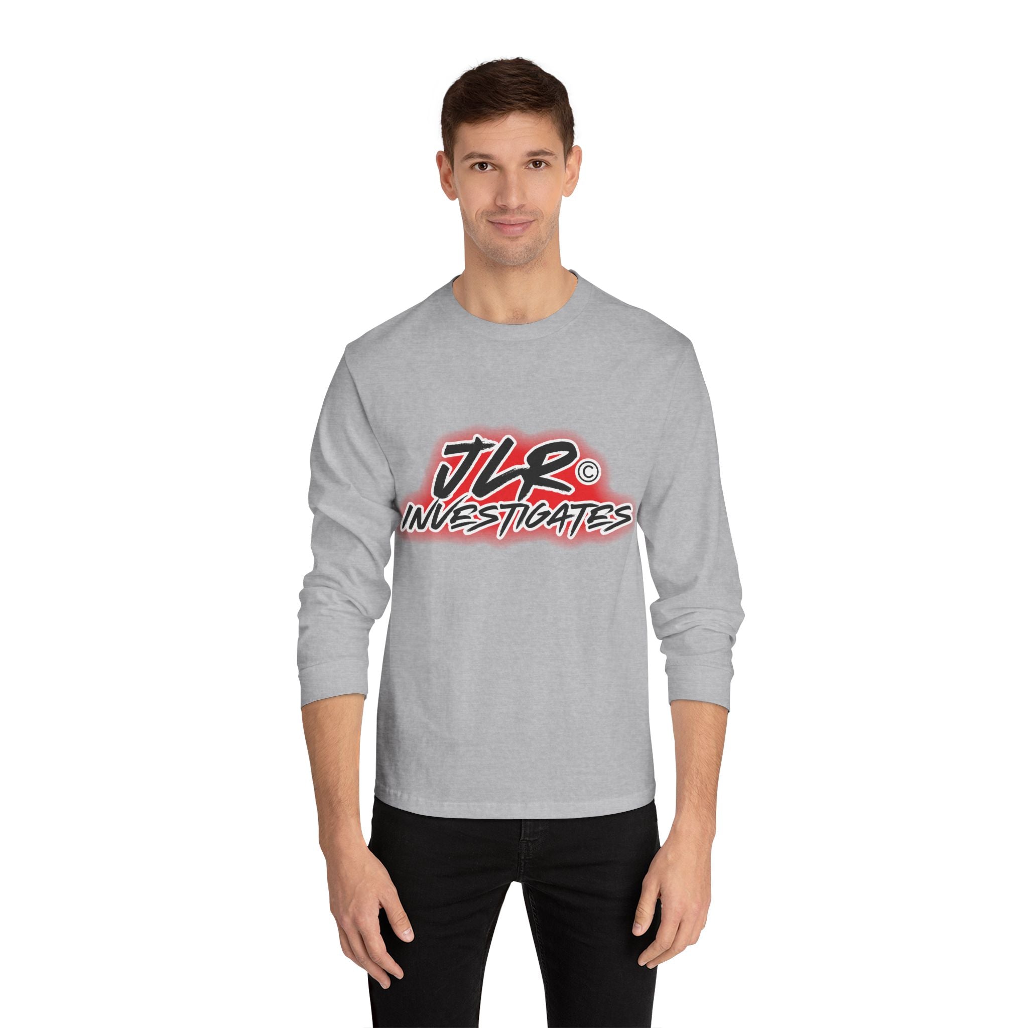 Man wearing grey long sleeve unisex t-shirt featuring bold 'JLR© Investigates' graffiti-style logo in red, white, and black.