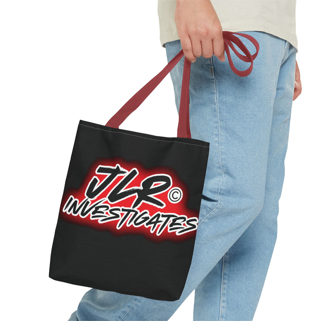Person holding a black tote bag with 'JLR Investigates' logo.