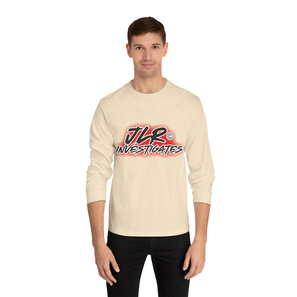 Man wearing Sand long sleeve unisex t-shirt featuring bold 'JLR© Investigates' graffiti-style logo in red, white, and black