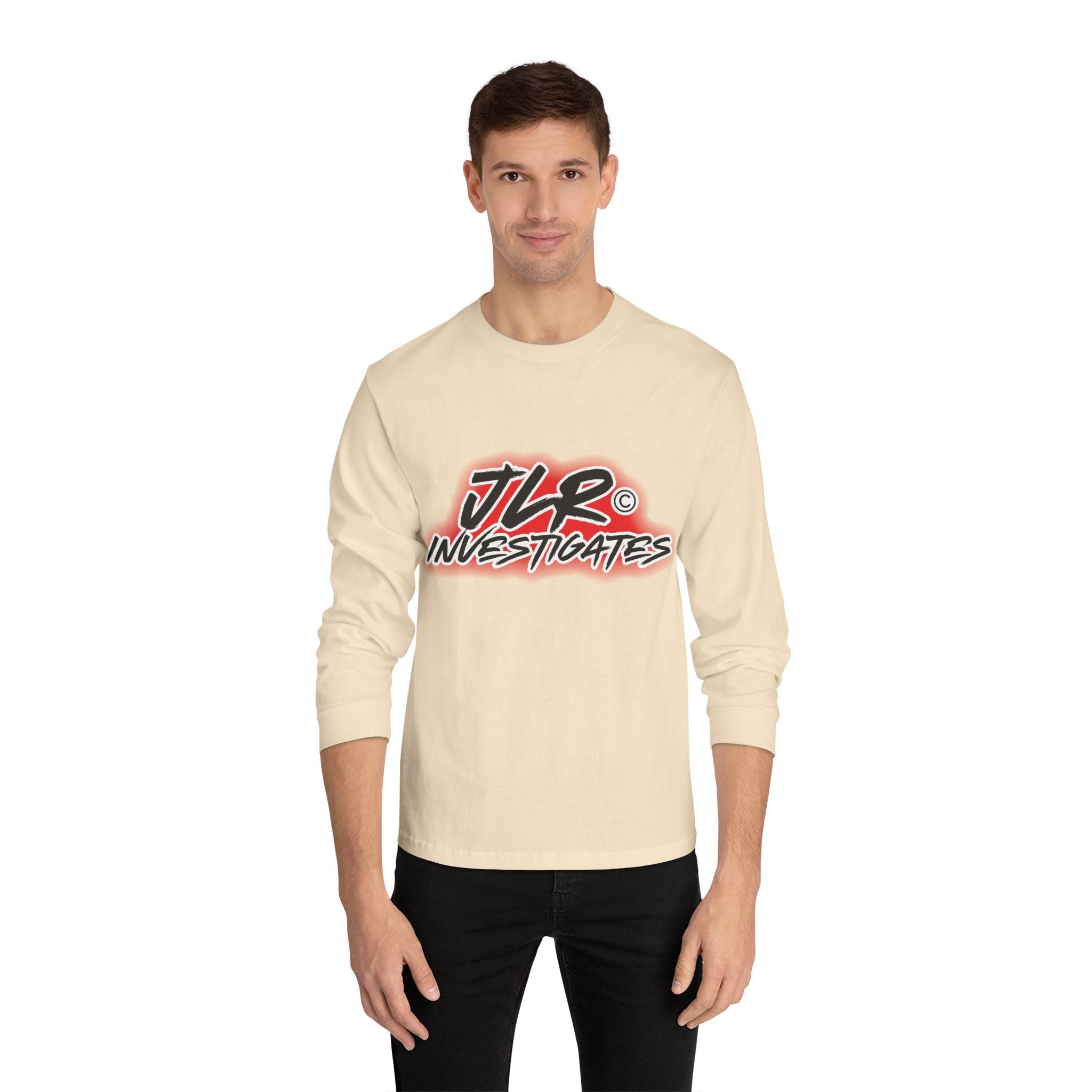 Man wearing Sand long sleeve unisex t-shirt featuring bold 'JLR© Investigates' graffiti-style logo in red, white, and black