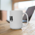 MEDIA JLR© mug on a desk beside a laptop.