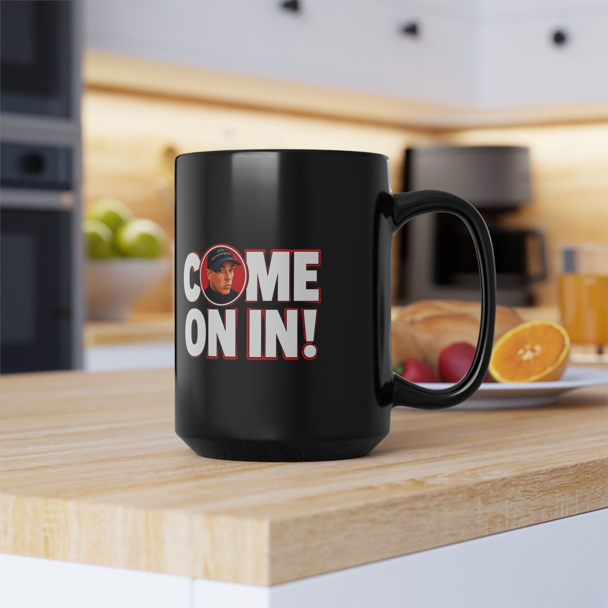 Black mug with 'COME ON IN!' text on a kitchen counter