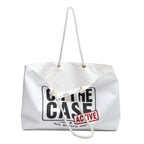 A white canvas tote bag with white rope handles, featuring a black graphic print that reads 'ON THE CASE' and a red stamp graphic that says 'ACTIVE'.