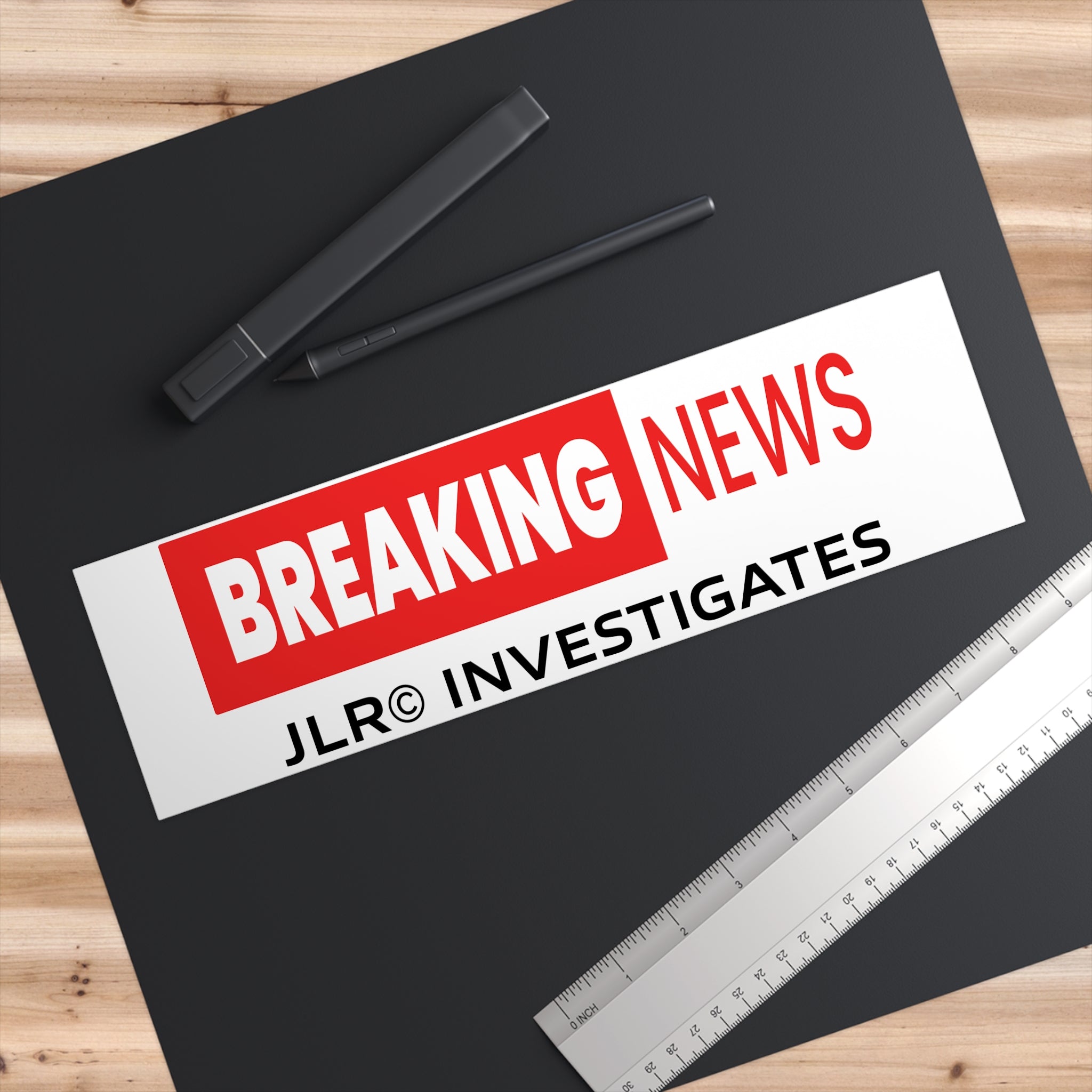 Close-up of Breaking News! vinyl sticker showing crisp red and white print — waterproof, fade-resistant, easy-peel backing