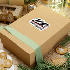 A die-cut sticker featuring the stylized text 'JLR INVESTIGATES' in black with red brushstroke accents and a white outline, shown on a cardboard box