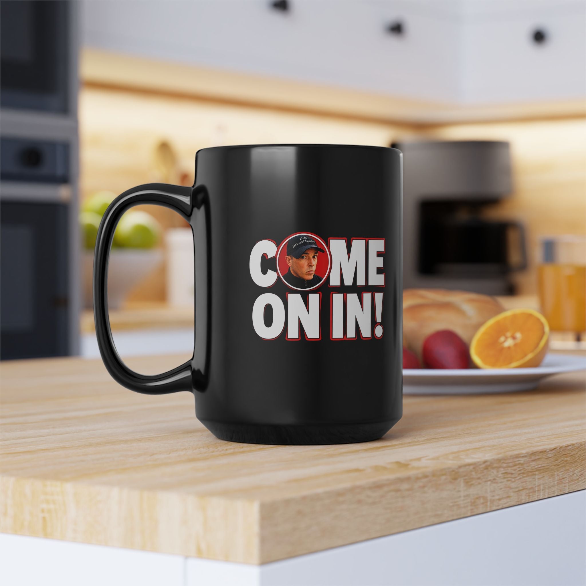 Black mug with 'COME ON IN!' text on a kitchen counter
