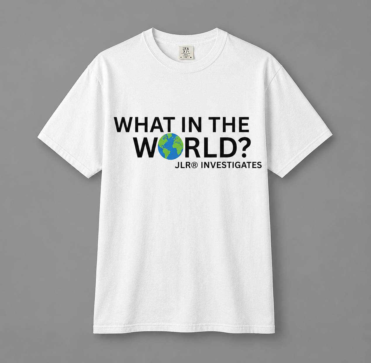 White unisex t-shirt featuring bold black text 'What in the World?' with a globe replacing the 'O' and 'JLR© Investigates' subtext below