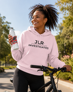 Woman on bicycle wearing light pink pullover hoodie with JLR Investigates logo in black