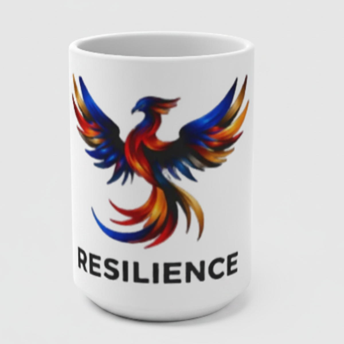 Resilience 15oz ceramic mug featuring a colorful phoenix graphic and bold RESILIENCE text on a white mug