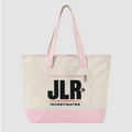 A canvas tote bag with an off-white body, light pink handles and bottom trim, and a large black 'JLR INVESTIGATES' logo printed on the front pocket, shown against a light gray background.