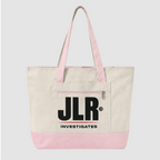 A canvas tote bag with an off-white body, light pink handles and bottom trim, and a large black 'JLR INVESTIGATES' logo printed on the front pocket, shown against a light gray background.