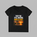 A black women's V-neck t-shirt with a graphic print on the front. The graphic features a sunset over water with an Adirondack chair, and the text 'THEY'RE STILL MISSING.