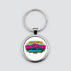 A silver metal round keychain with a printed graphic that reads 'JUST ANOTHER WHACKADOBLE WEDNESDAY!' in colorful comic-style lettering, shown on a light grey background.