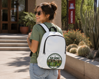 Woman wearing JLR Army Official Member white backpack outdoors — lifestyle shot — JLR Investigates